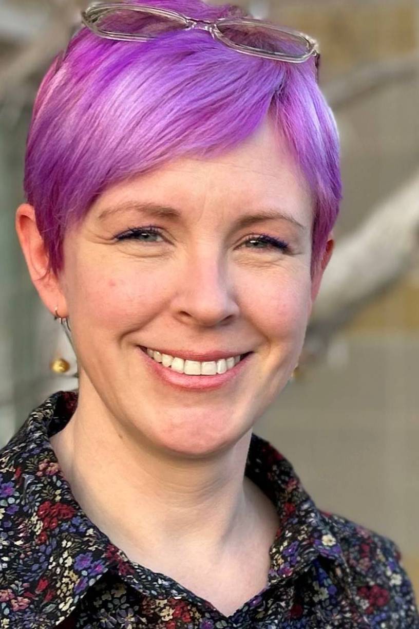 woman with purple hair and floral shirt