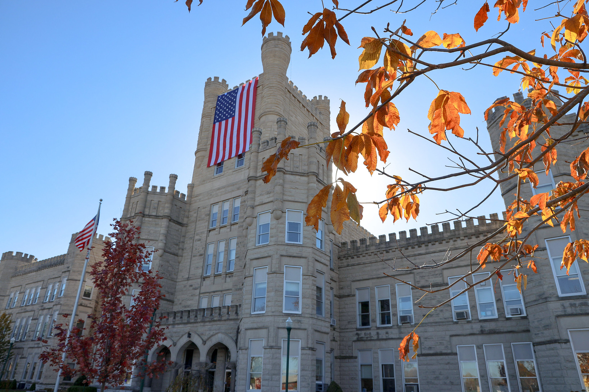 A large American flag hangs off Old Main A large American flag hangs off Old Main