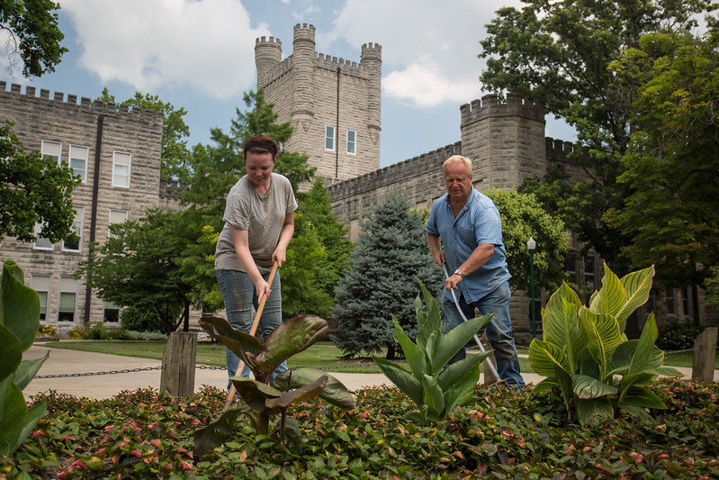 Grounds gardener Larry Shobe and student worker Kelly Follis, a senior sociology major, at work on the campus of Eastern Illinois University in Charleston, Illinois on July 18, 2013.