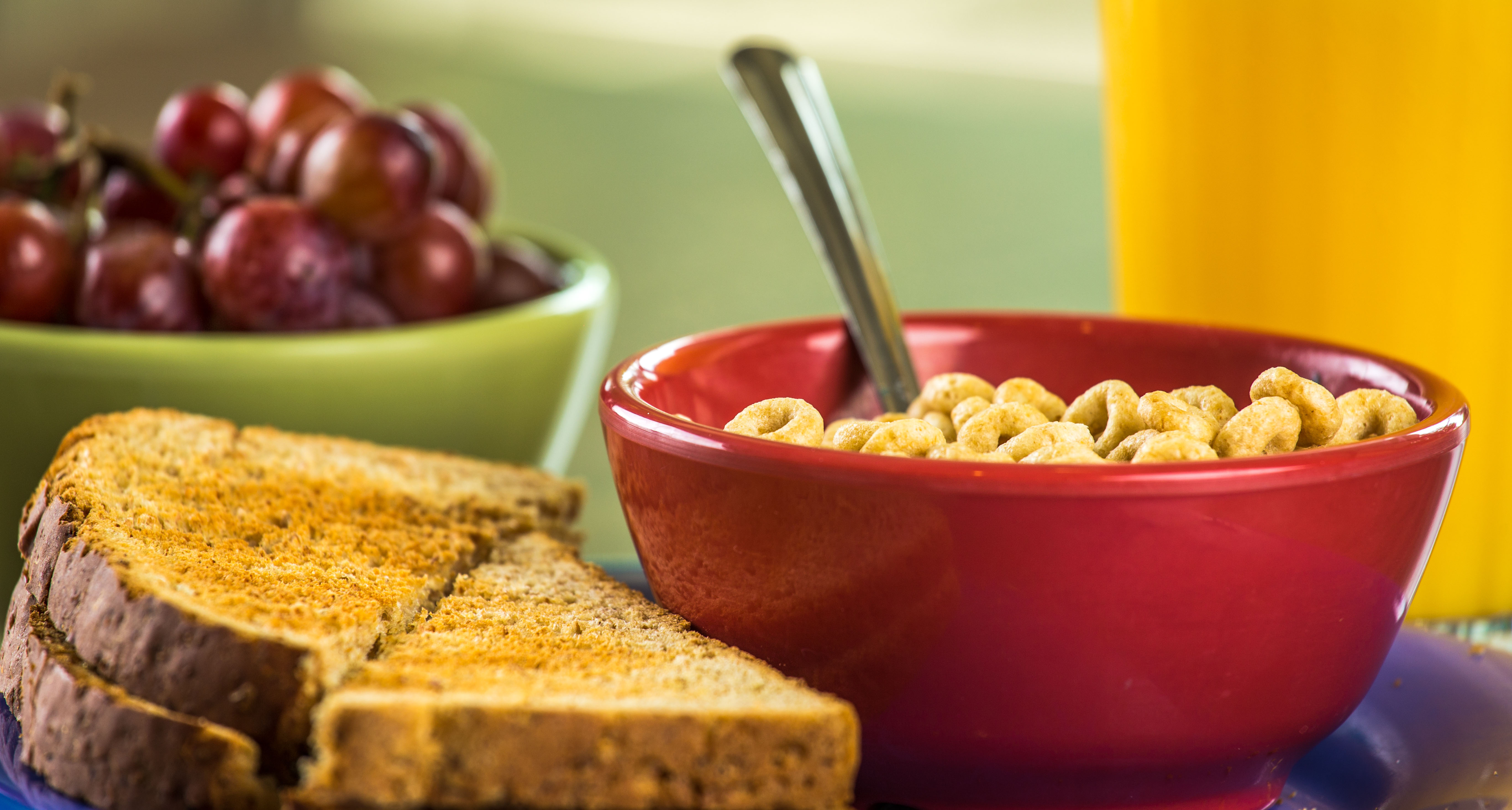 Image of grapes, cereal, toast, and orange juice