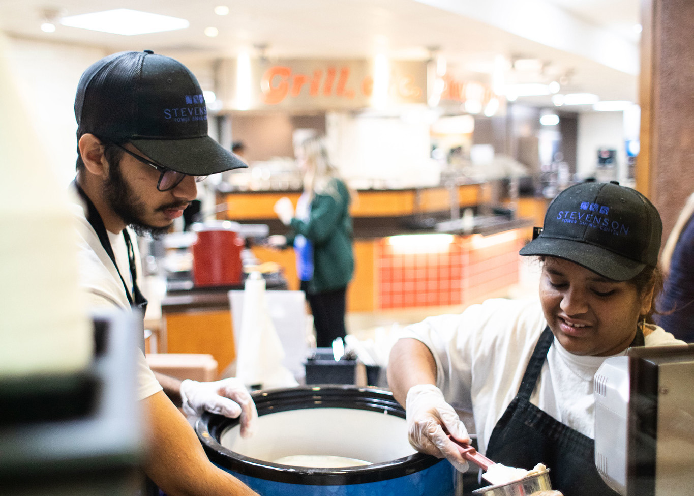two students working in dining services
