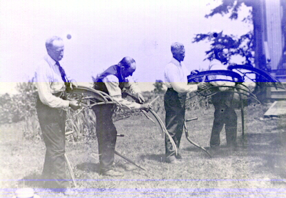 four men sharpening blades