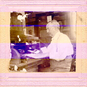 man working at rolltop desk