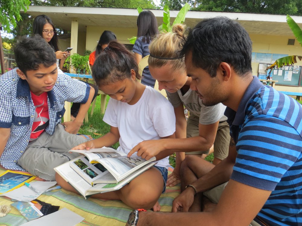 group of children reading a book