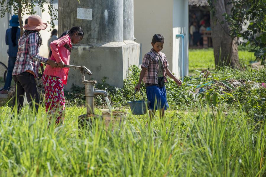 children carrying water in cambodia