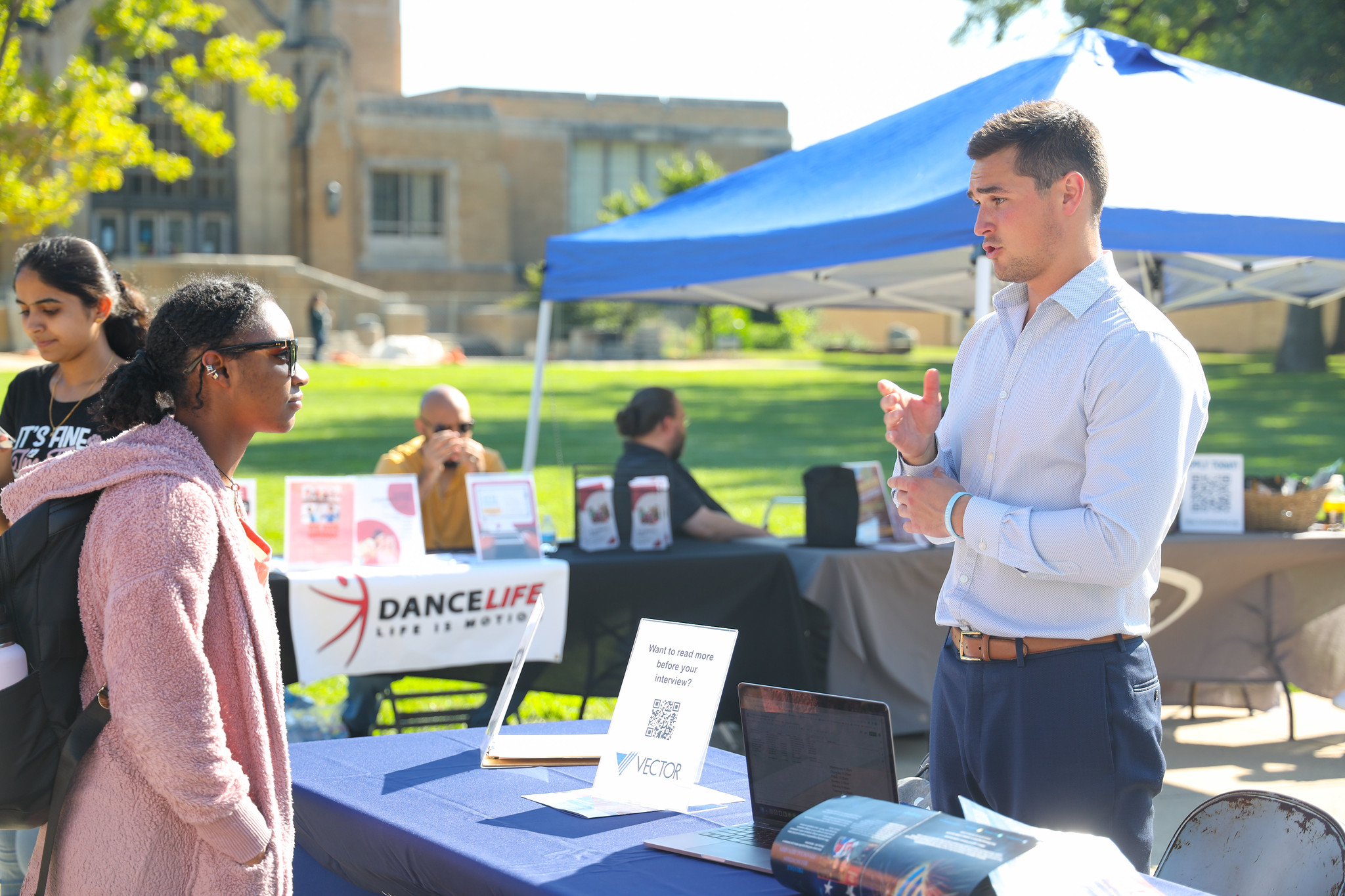 Student talking to a prospective employer at a campus career fair