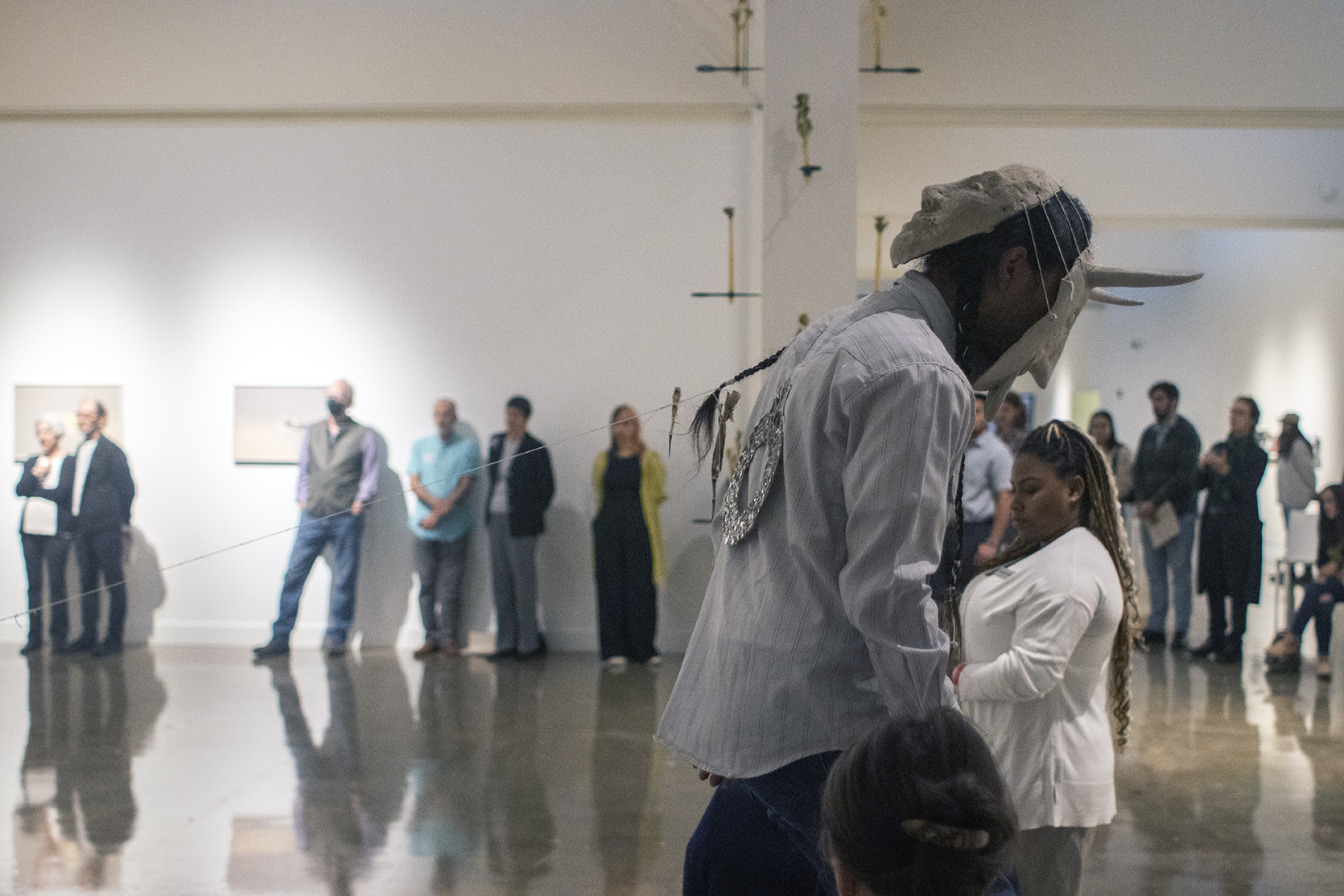 Visitors watch a performance by Armando Guadalupe Cortés at the Fall 2022 Exhibition Cycle Opening Reception.